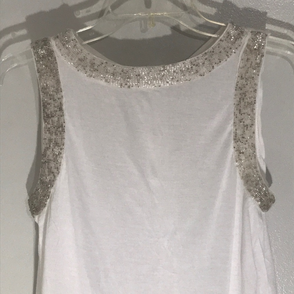 Women’s beaded cream top with button back detail